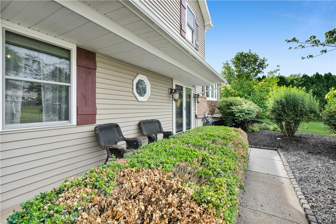 3396 Darien Road Bethlehem, PA 18020 - Photo 3 of 44 A welcoming entry framed by lush greenery and a manicured hedge, offering a serene outdoor retreat.