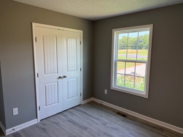 12 Hesselly Road Decherd, TN 37324 - Photo 10 of 13 an empty room with wooden floor and windows