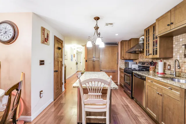 a view of a kitchen with a sink and refrigerator