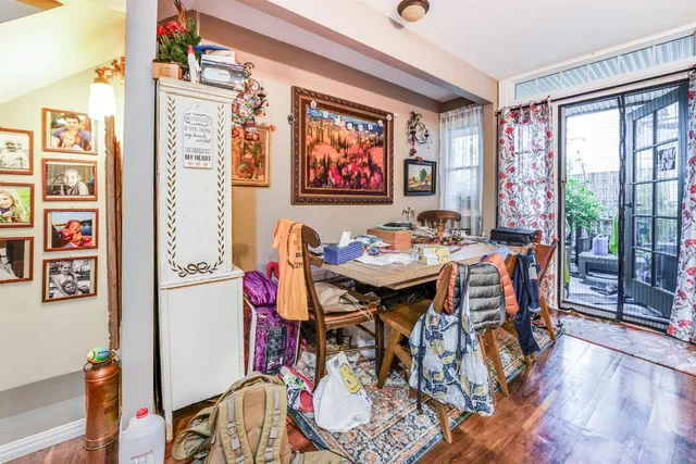 a view of a dining room with furniture large window and wooden floor
