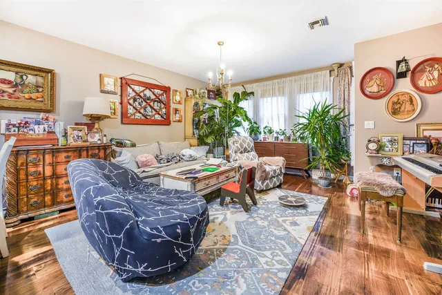 a living room with furniture and a chandelier