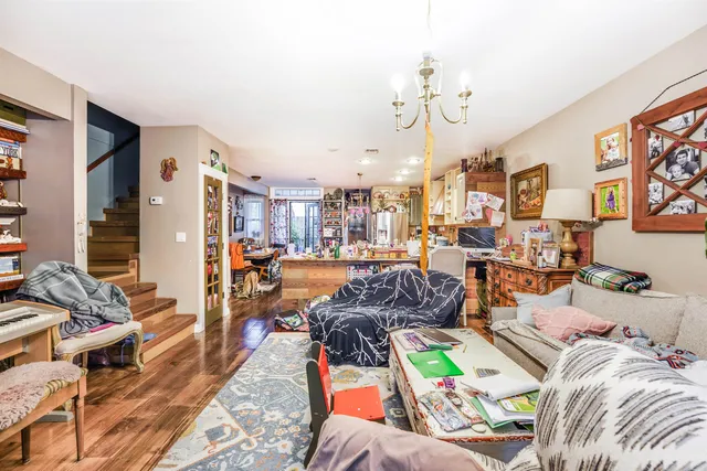 a living room with lots of furniture and a chandelier