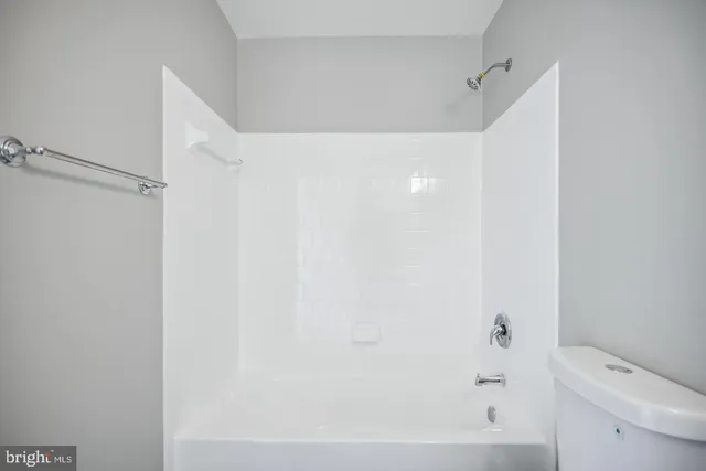 a bathroom with a bathtub and a toilet