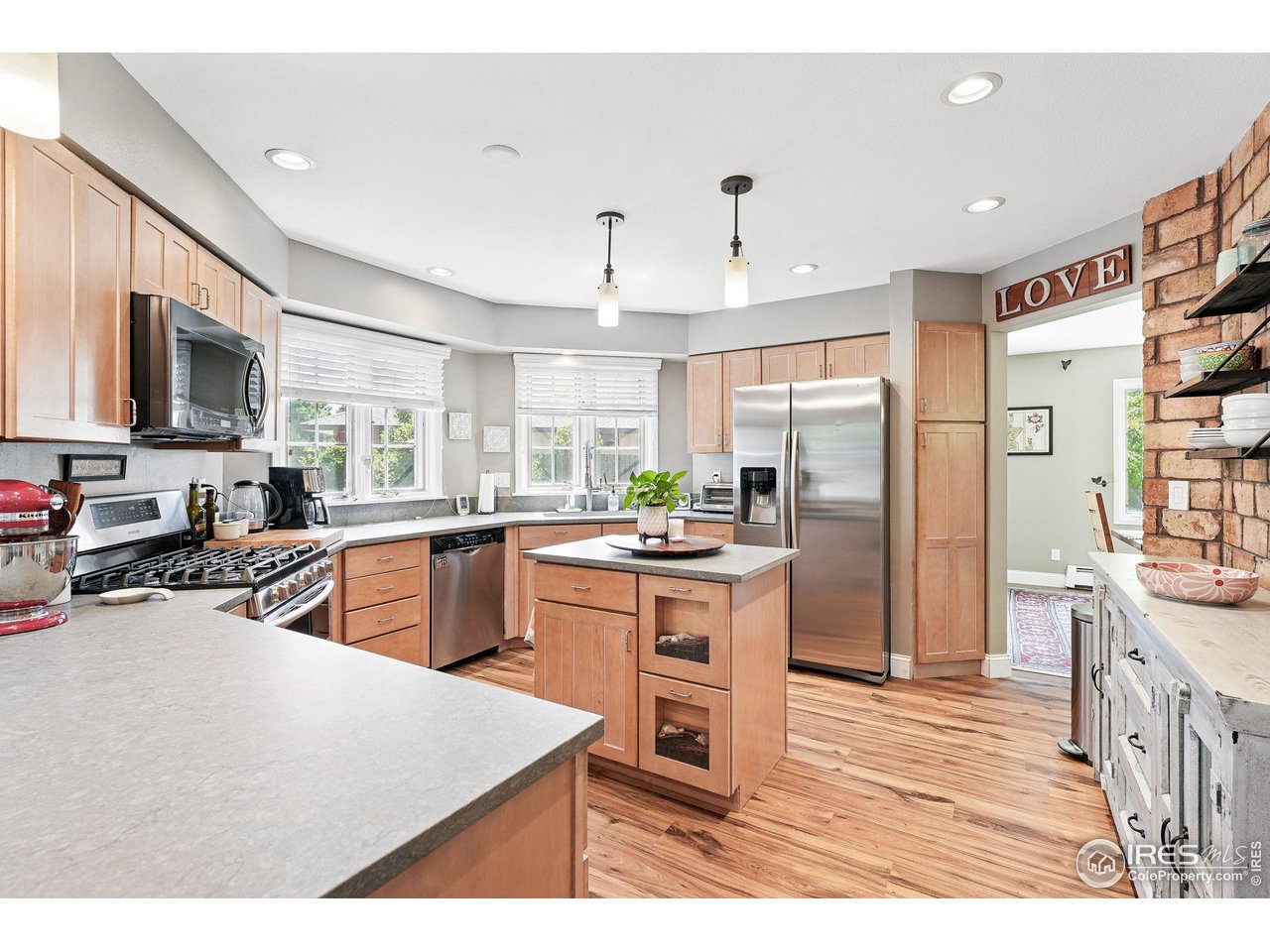 6850 Frying Pan Road Boulder, CO 80301 - Photo 12 of 40 Kitchen features matte finish quartz countertops, stainless steel appliances, a center island, and updated light fixtures