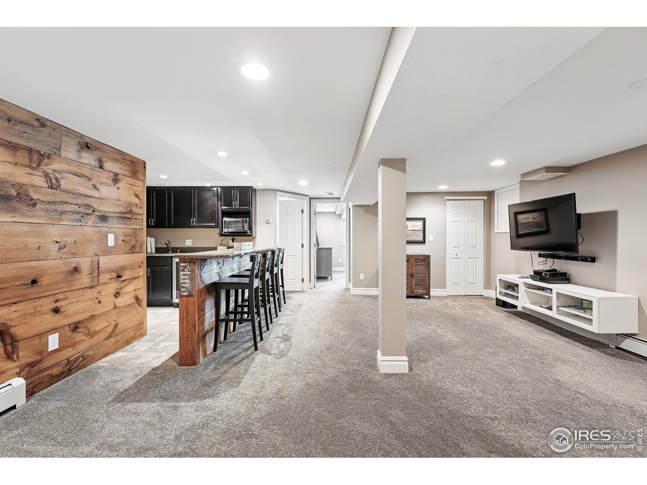 6850 Frying Pan Road Boulder, CO 80301 - Photo 26 of 40 Professionally finished basement with a large recreation room, wet bar, bathroom, and a fourth bedroom featuring a daylight window