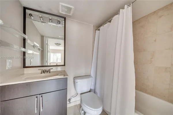 a bathroom with a toilet a sink and a mirror