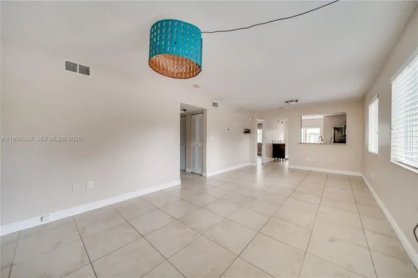 a view of a kitchen with a sink and a chandelier