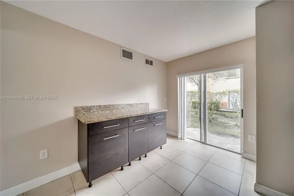 a spacious bathroom with a granite countertop sink and a mirror