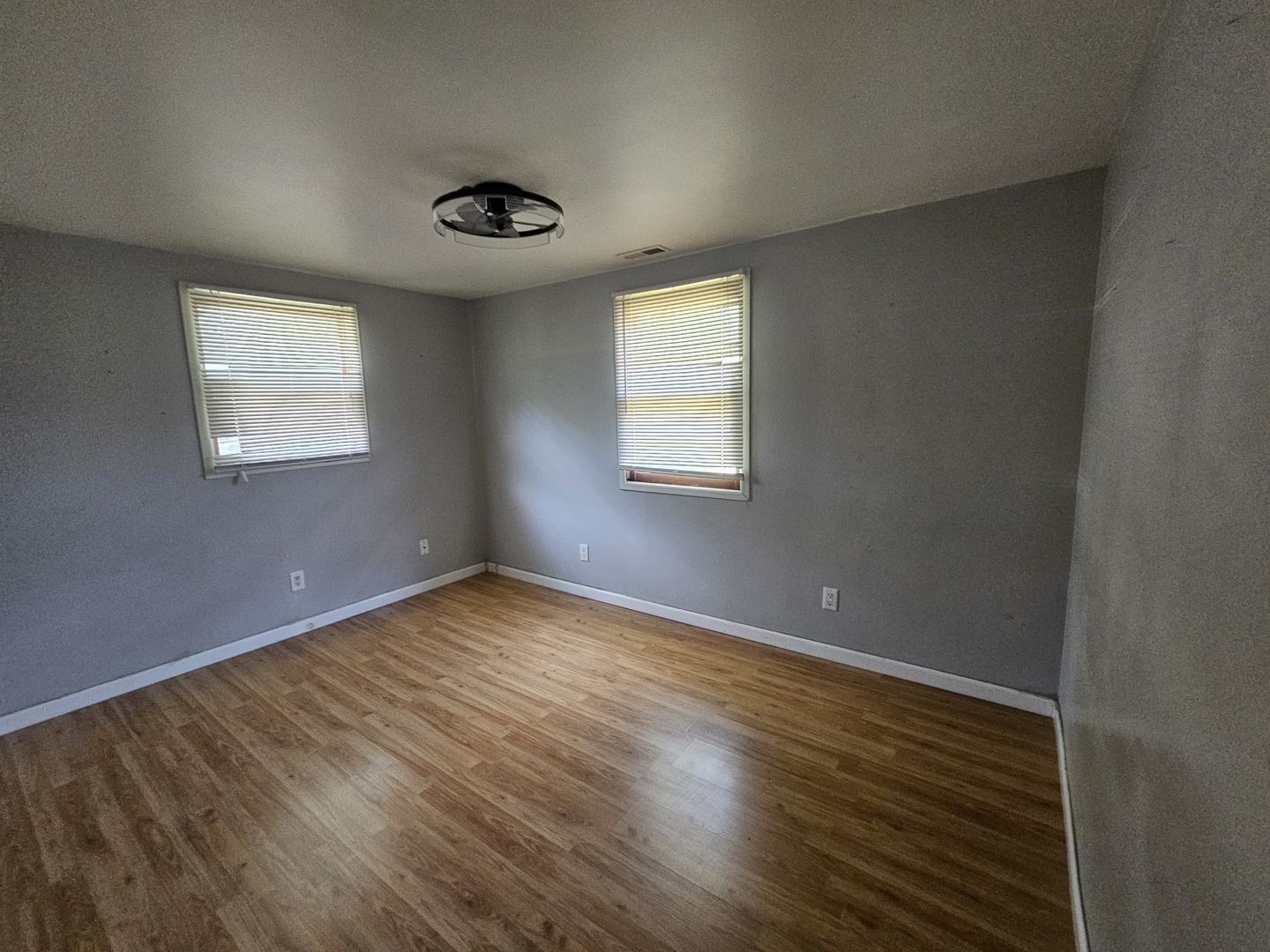 10N827 Hawthorne Street Elgin, IL 60123 - Photo 10 of 14 an empty room with wooden floor and windows