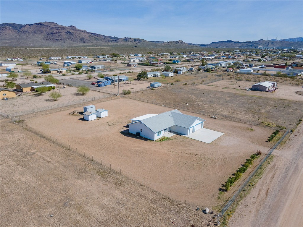 3411 West Carmichael Road Golden Valley, AZ 86413 - Photo 90 of 97 Aerial view of sparsely populated area featuring a mountain backdrop and nearby suburban area