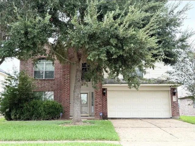 a view of a house with a tree