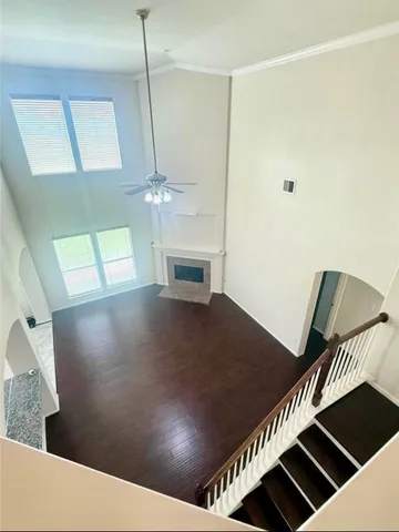 a view of a livingroom with a flesh screen tv and stairs