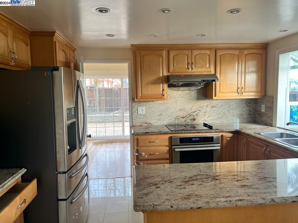 1064 Dempsey Road Milpitas, CA 95035 - Photo 11 of 31 a kitchen with kitchen island granite countertop a stove and a sink