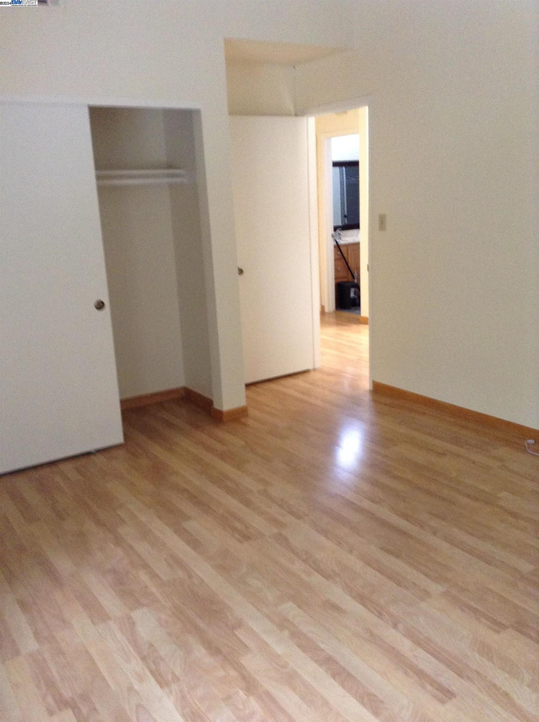1064 Dempsey Road Milpitas, CA 95035 - Photo 17 of 31 a view of an empty room with wooden floor and closet