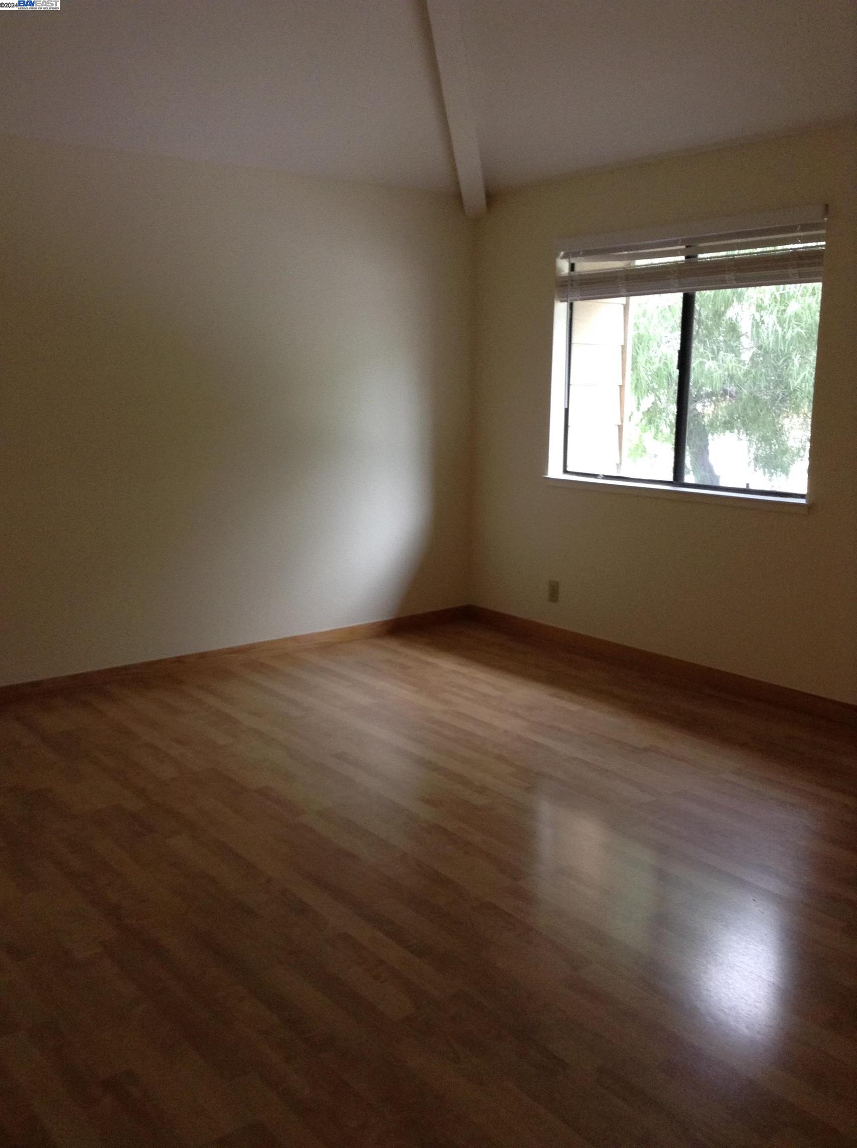 1064 Dempsey Road Milpitas, CA 95035 - Photo 18 of 31 a view of an empty room with wooden floor and a window
