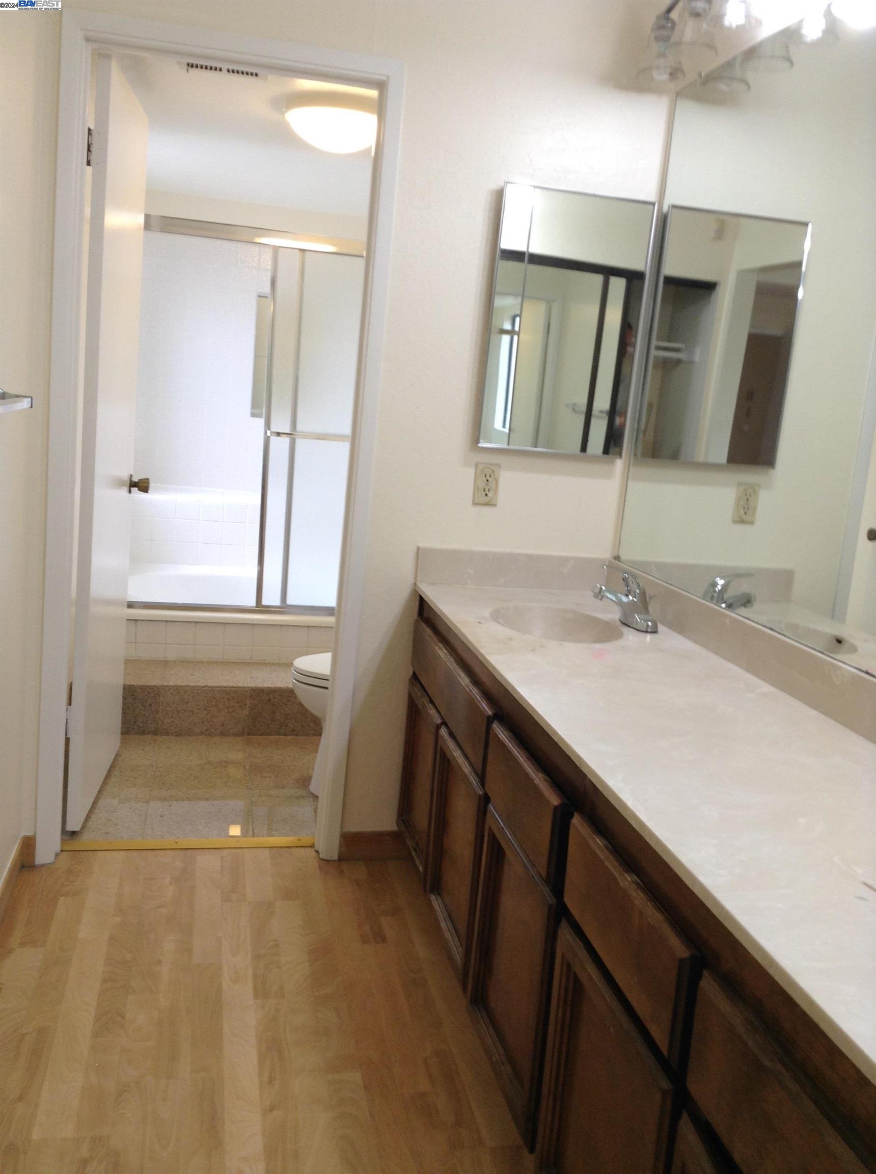 1064 Dempsey Road Milpitas, CA 95035 - Photo 21 of 31 a bathroom with a sink a vanity and a mirror