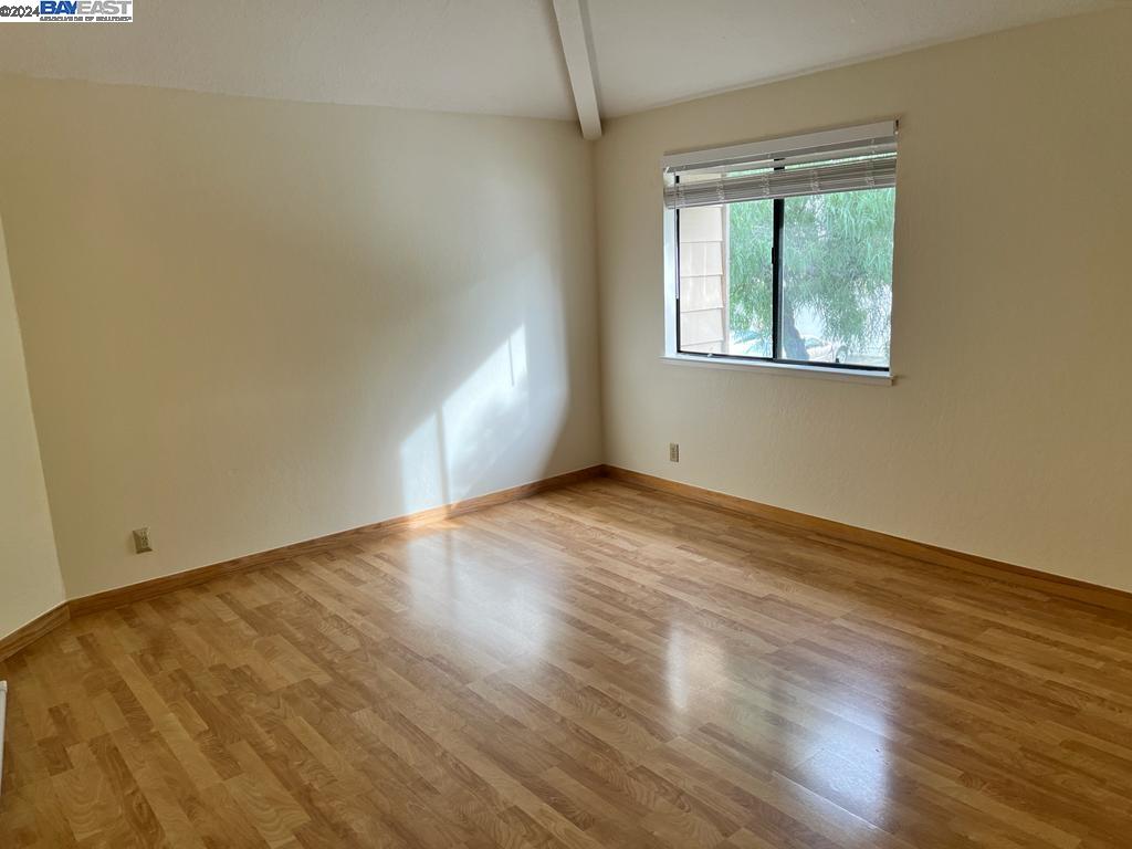 1064 Dempsey Road Milpitas, CA 95035 - Photo 23 of 31 an empty room with wooden floor and windows