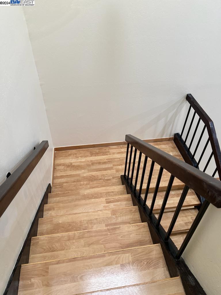 1064 Dempsey Road Milpitas, CA 95035 - Photo 25 of 31 a view of staircase with lots of frames on wall