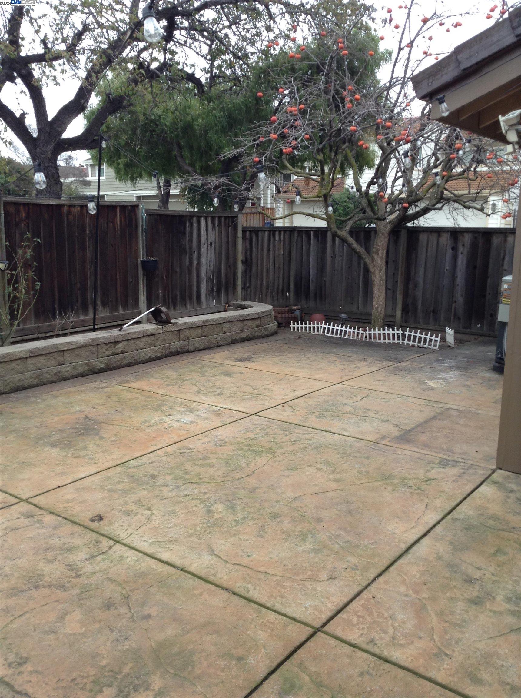 1064 Dempsey Road Milpitas, CA 95035 - Photo 30 of 31 a view of backyard with wooden fence and a large tree