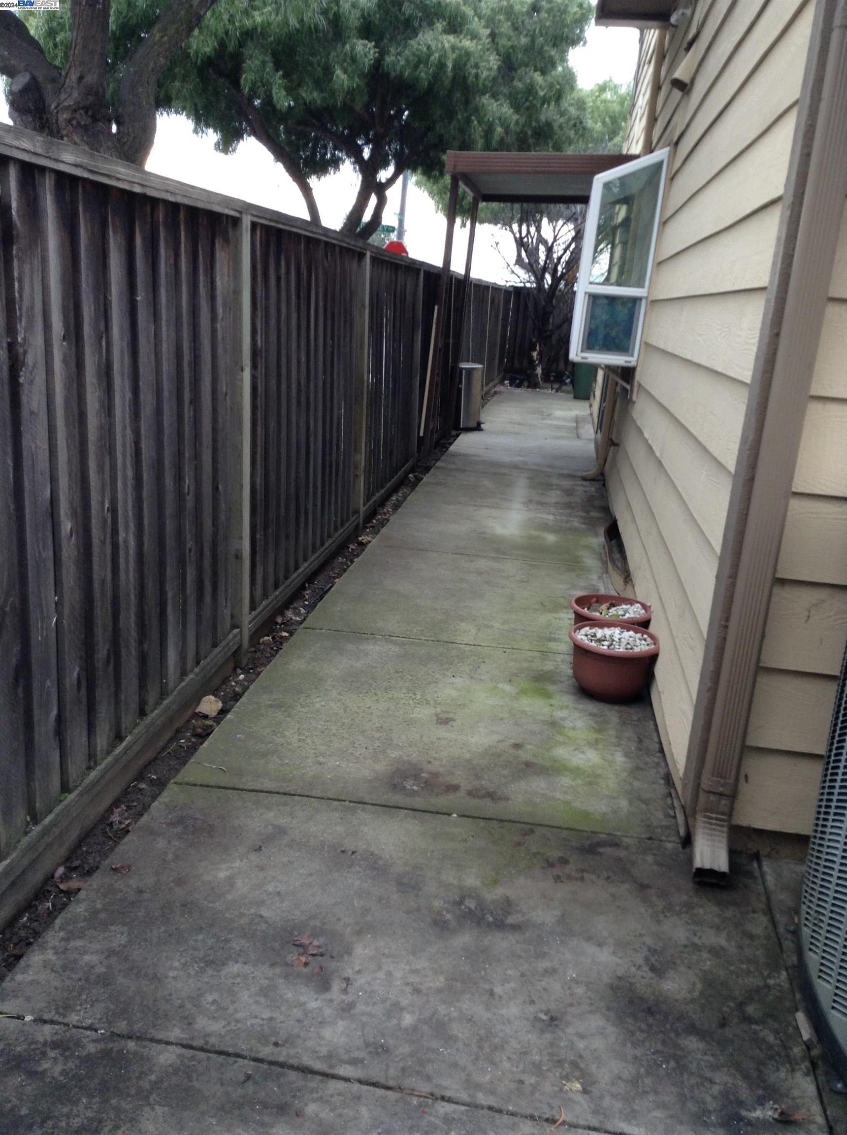 1064 Dempsey Road Milpitas, CA 95035 - Photo 3 of 31 a view of a backyard with wooden fence and some plants