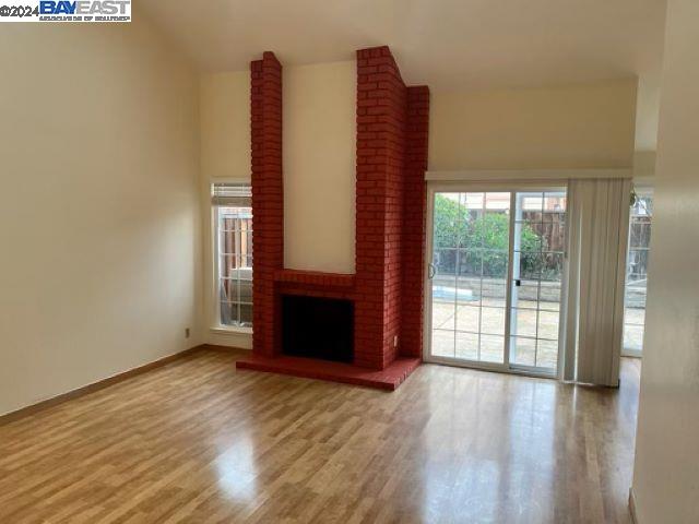 1064 Dempsey Road Milpitas, CA 95035 - Photo 7 of 31 a view of an empty room with wooden floor and a window