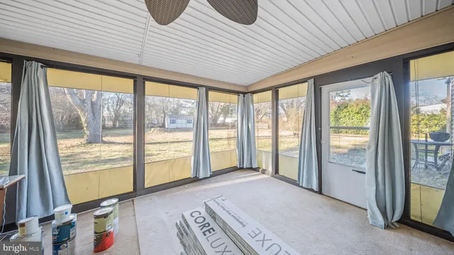 a bedroom with furniture and large windows