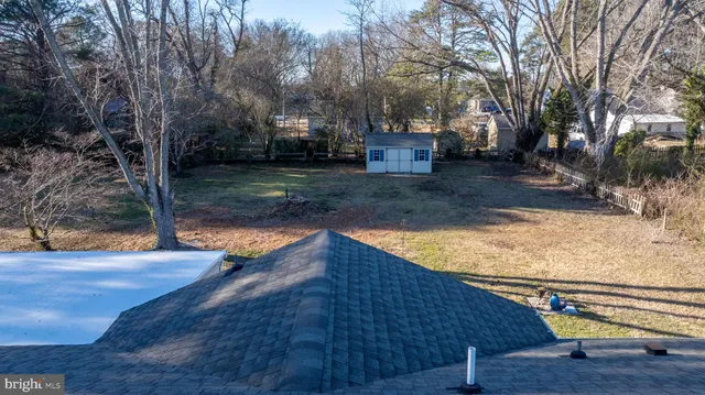 a view of a yard with wooden fence