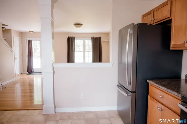 a metallic refrigerator freezer sitting in a kitchen