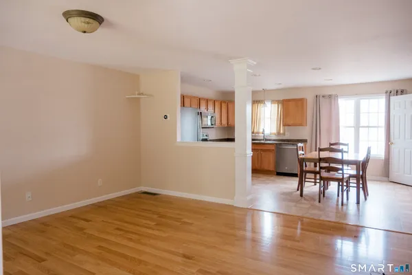 a view of a dining room with furniture and wooden floor