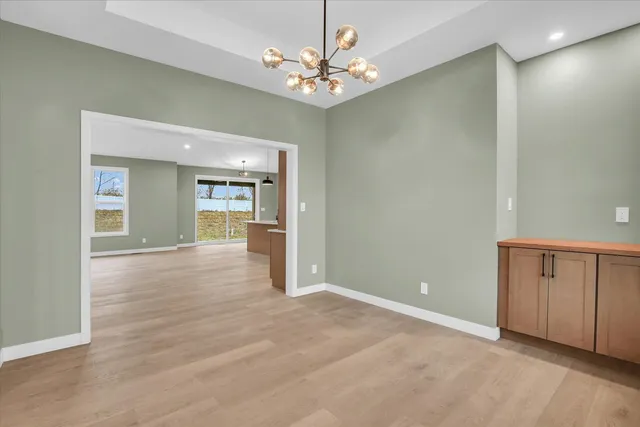a view of an empty room with a kitchen