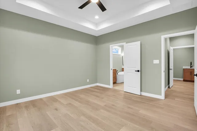 an empty room with fan and entrance