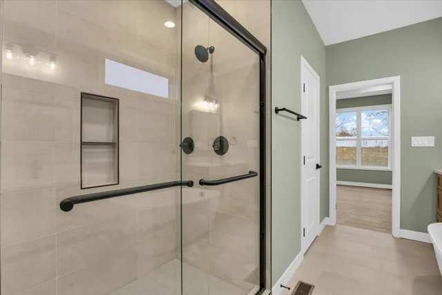 a bathroom with a glass shower door