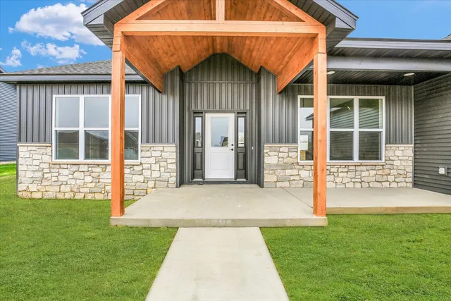 a front view of a house with a garden