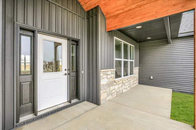 a view of a porch with a door and wooden floor