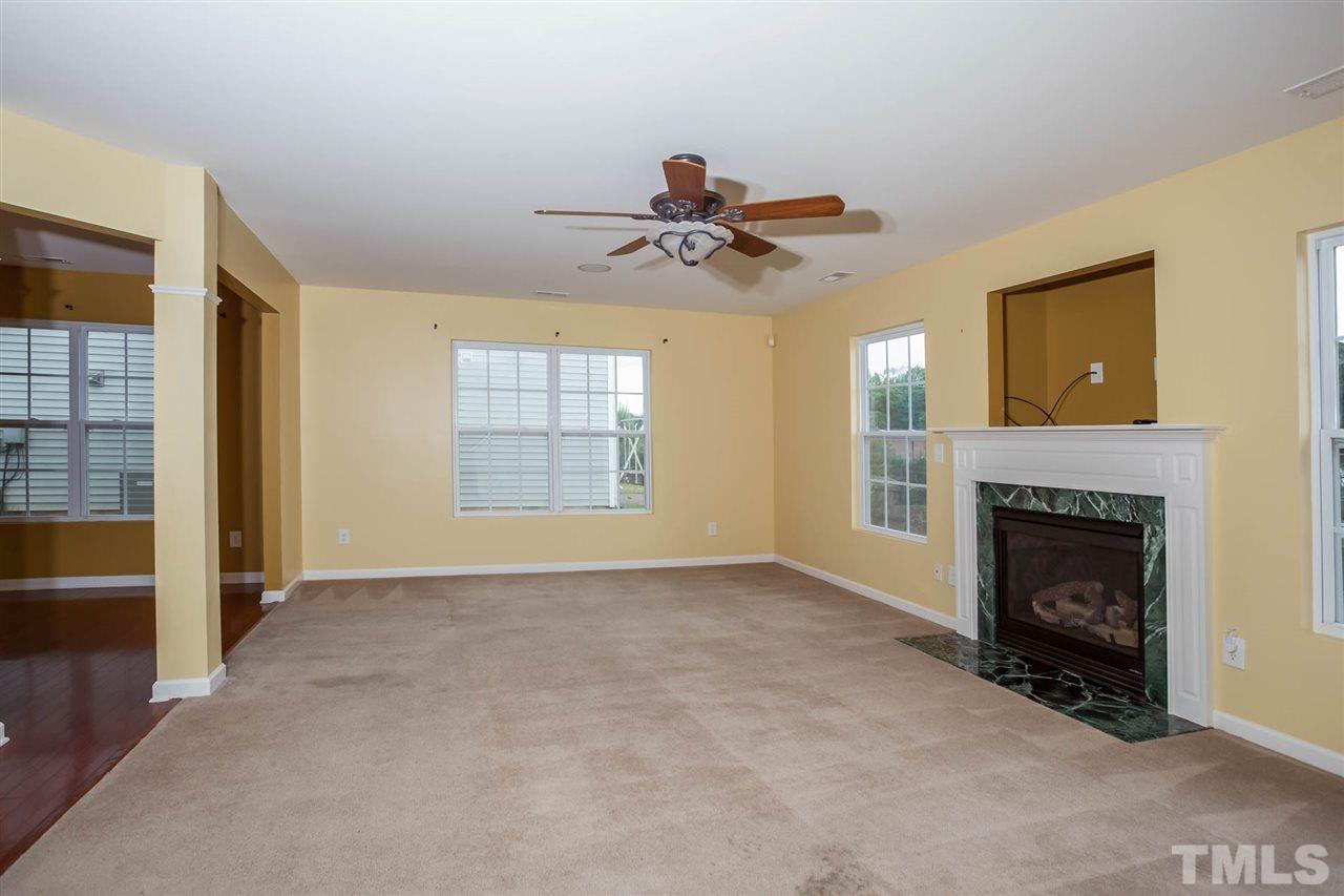 3731 Burtons Barn Street Raleigh, NC 27610 - Photo 4 of 13 a view of empty room with fireplace and windows