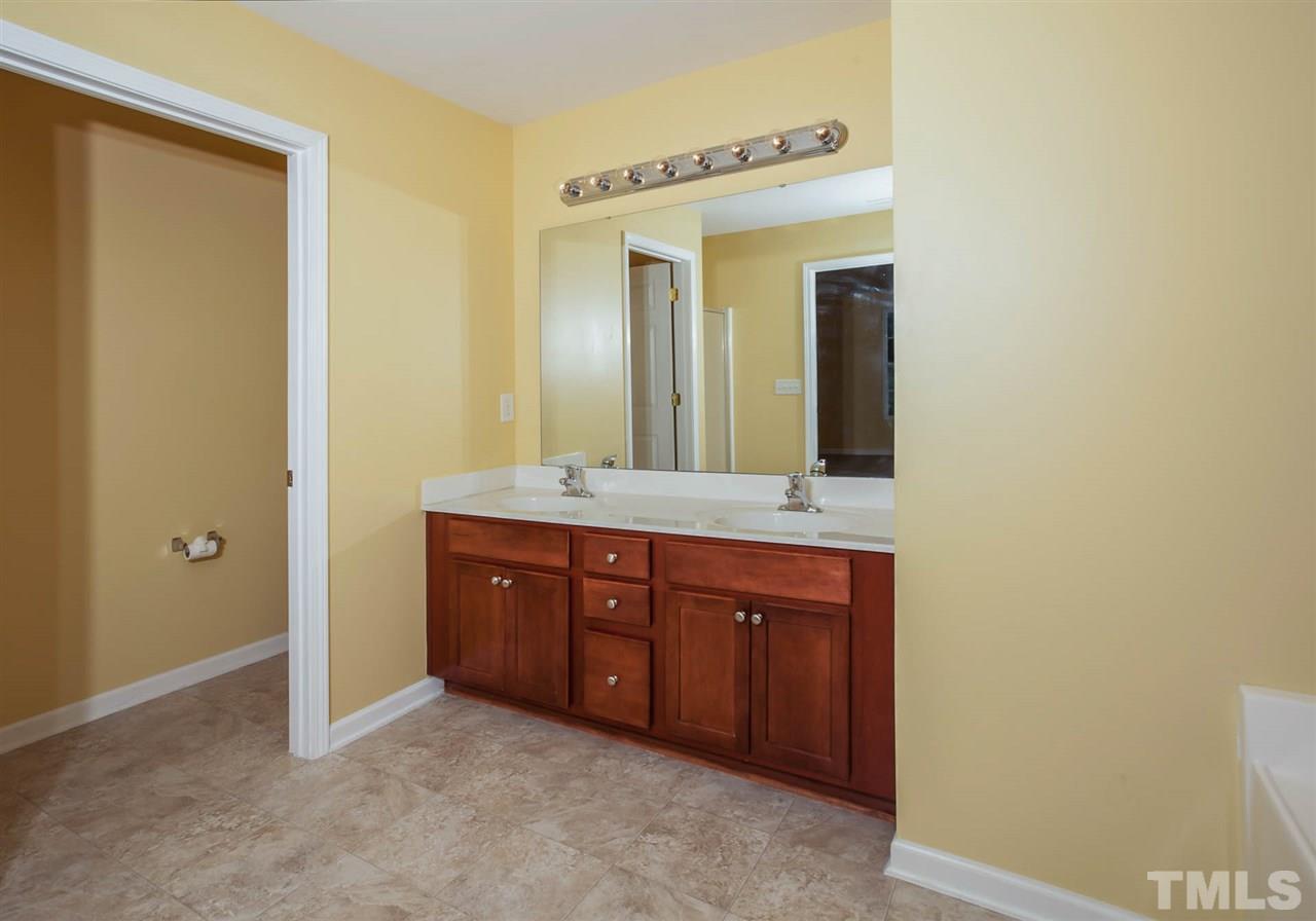 3731 Burtons Barn Street Raleigh, NC 27610 - Photo 7 of 13 a bathroom with a granite countertop sink and a mirror