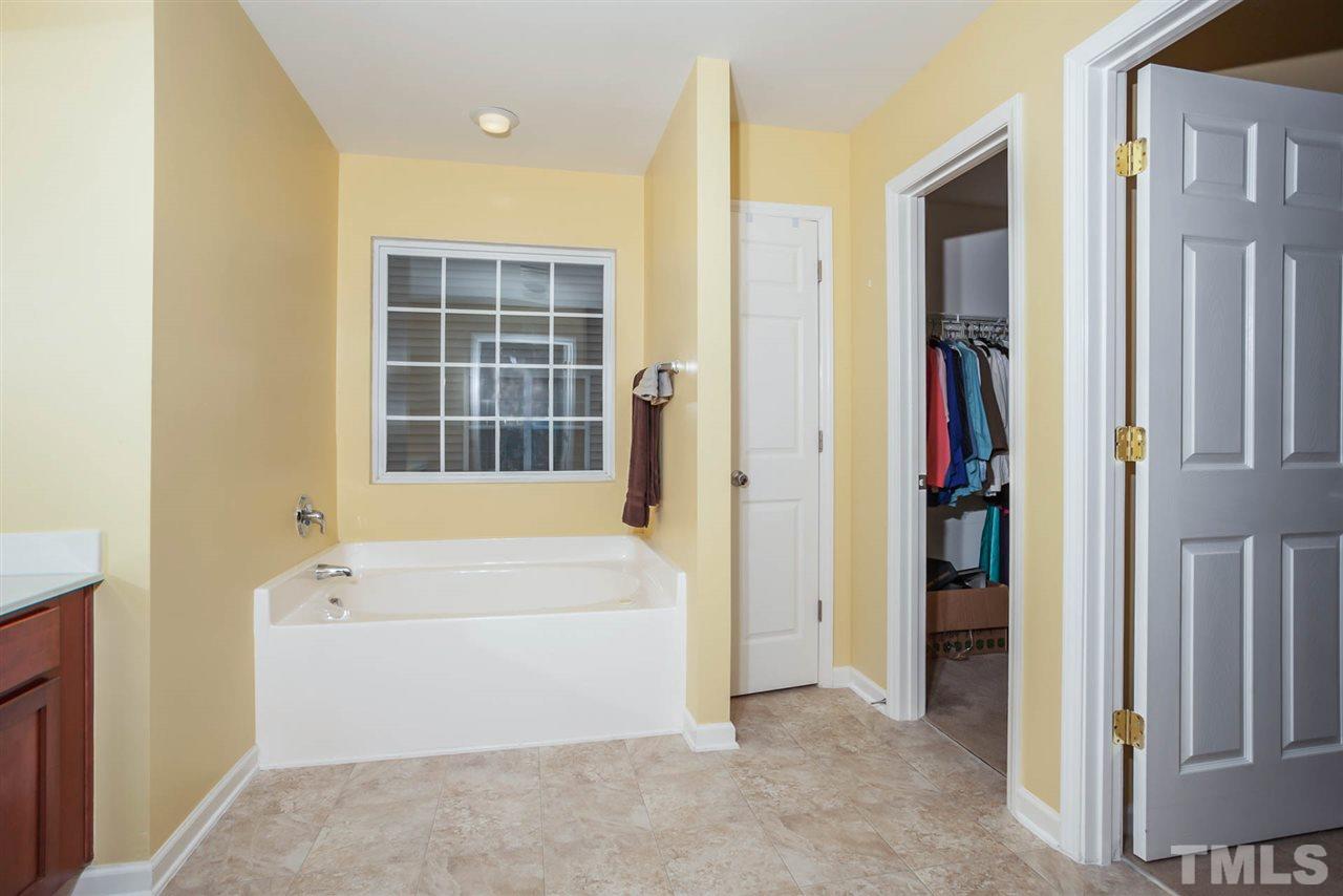 3731 Burtons Barn Street Raleigh, NC 27610 - Photo 8 of 13 a spacious bathroom with a bathtub and a shower