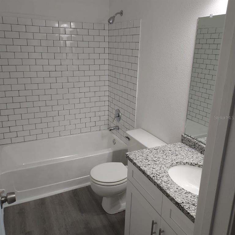 2929 Kelly Ridge Lane Tampa, FL 33604 - Photo 8 of 11 a bathroom with a granite countertop toilet a sink and bathtub