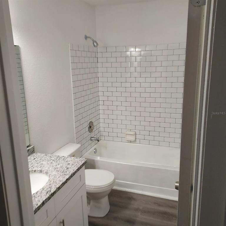 2929 Kelly Ridge Lane Tampa, FL 33604 - Photo 9 of 11 a bathroom with a granite countertop toilet a sink and bathtub