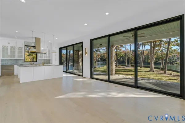 a view of an empty room with large windows