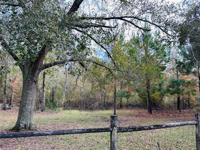 a view of a house with wooden fence