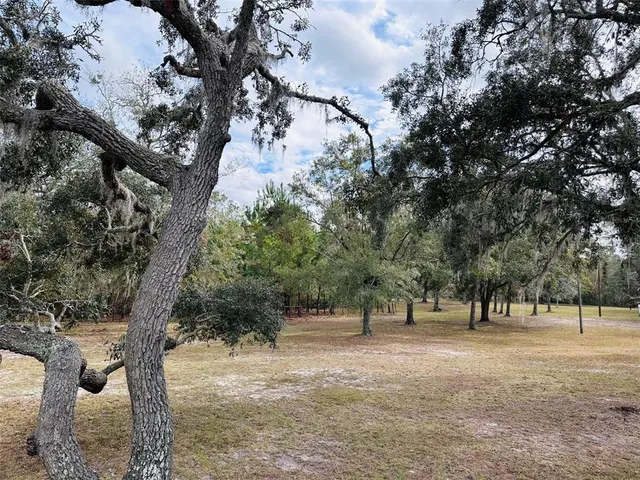 a view of a roof deck with wooden fence and a couple of chairs