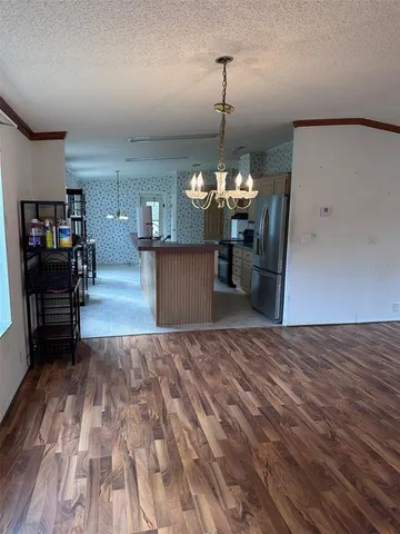 a kitchen with stainless steel appliances granite countertop a stove top oven a sink a counter top space and cabinets