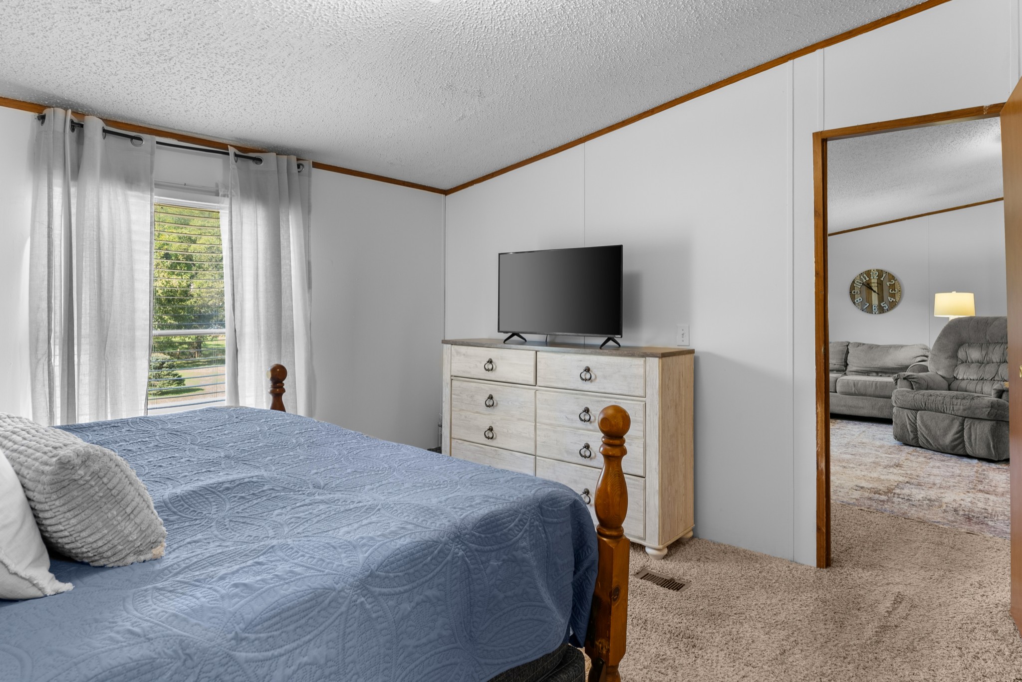 5147 Wiley Hollow Road Culleoka, TN 38451 - Photo 14 of 29 a bedroom with a bed and a flat tv screen on wall
