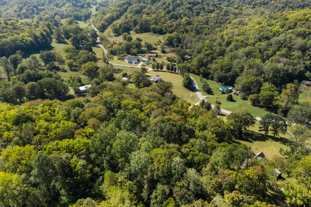 an aerial view of a houses with a yard