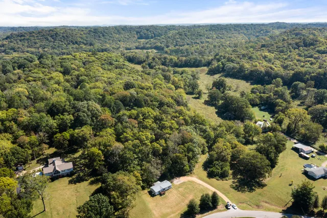 a roof deck with table and chairs under an umbrella