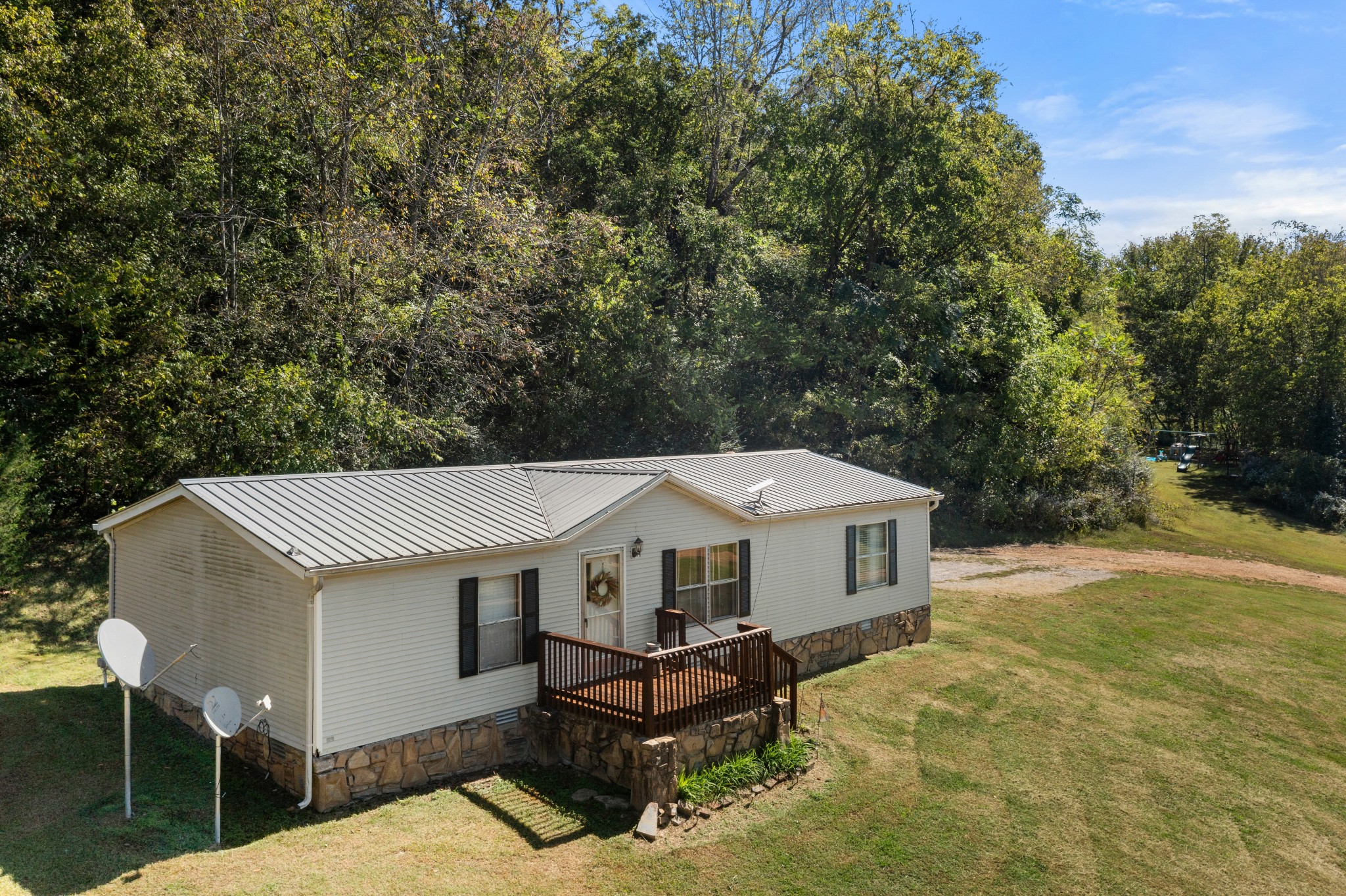 5147 Wiley Hollow Road Culleoka, TN 38451 - Photo 28 of 29 a roof deck with table and chairs under an umbrella