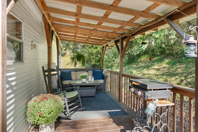 a kitchen with stainless steel appliances kitchen island granite countertop a refrigerator a stove top oven a sink dishwasher and white cabinets with wooden floor