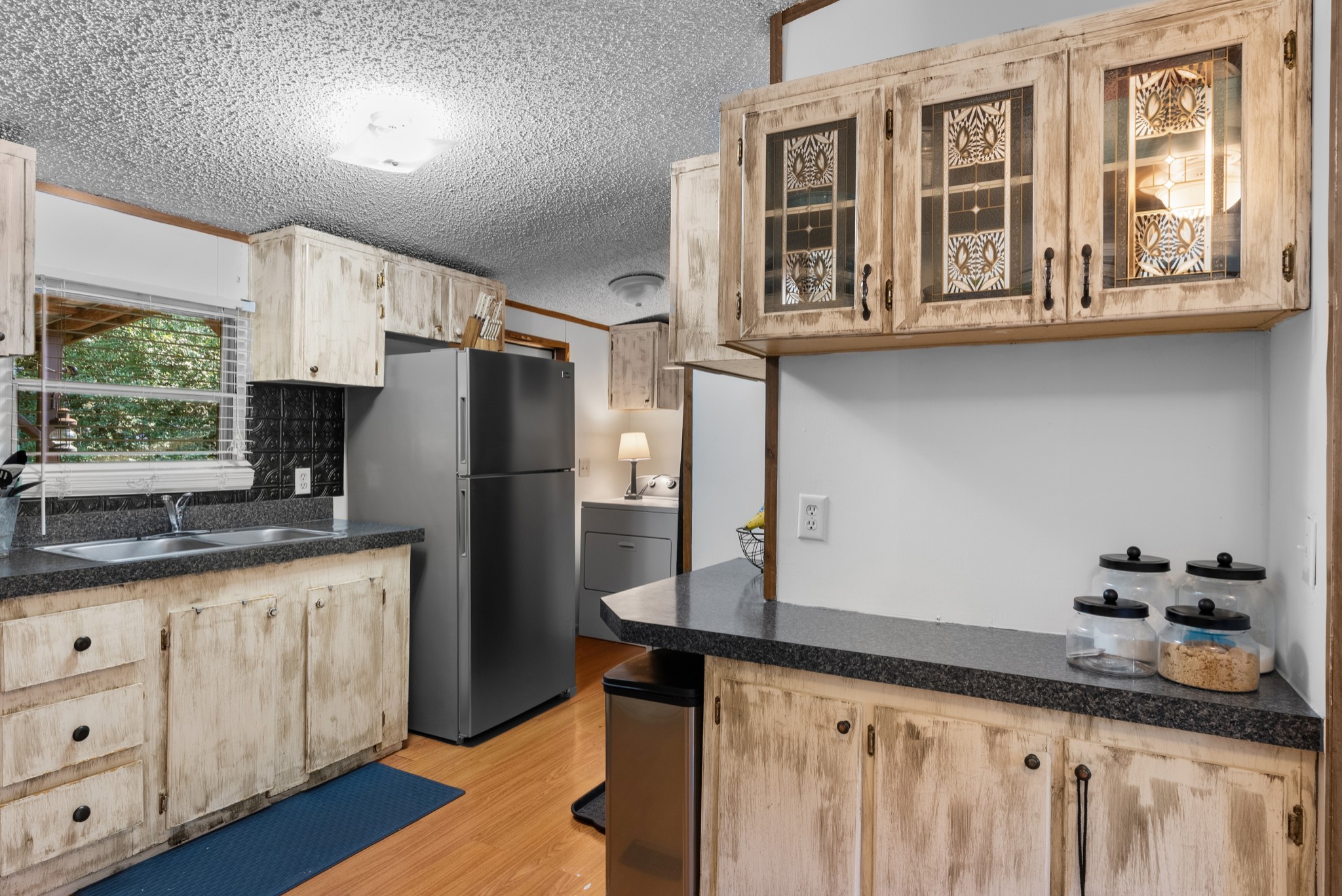 5147 Wiley Hollow Road Culleoka, TN 38451 - Photo 8 of 29 a kitchen with stainless steel appliances granite countertop a refrigerator a stove and a sink with wooden floor