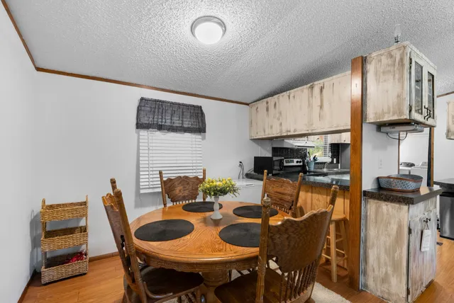 a living room with furniture a dining table and chairs with wooden floor